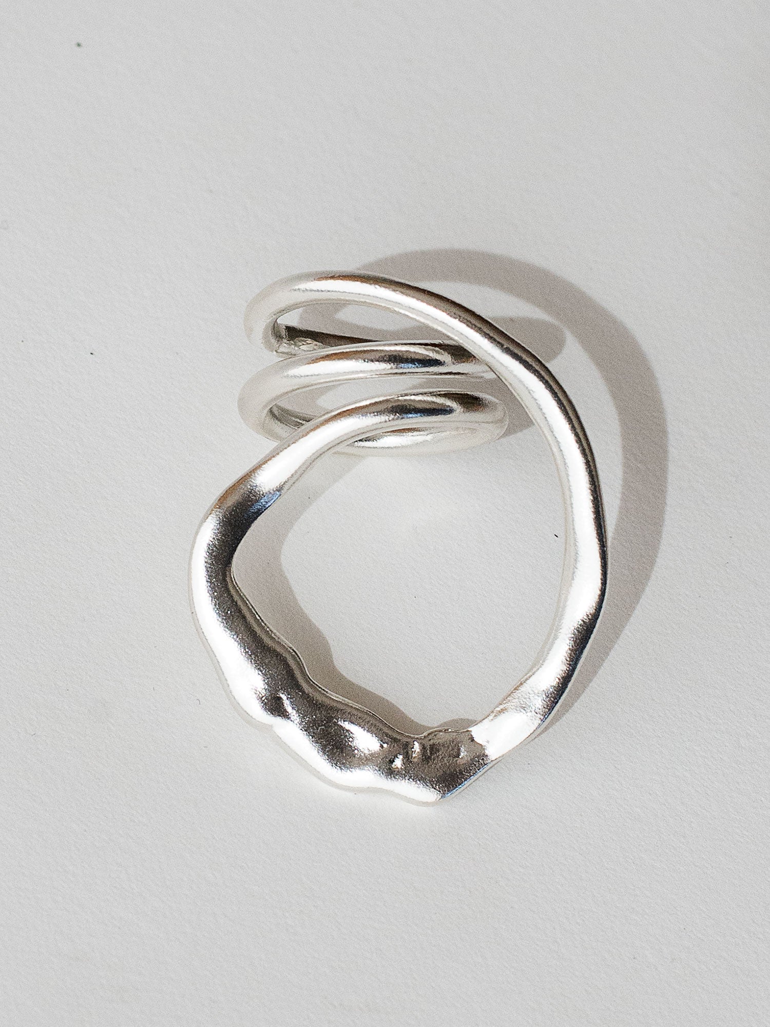 A handmade solid sterling silver ring in an artistic twisting shape by Michele Ross in Toronto, Canada