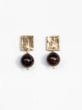 Pair of earrings with brass square tops and garnet beads by Michelle Ross