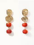 A pair of brass and red drop coral beaded  dangly earrings by Canadian jewelry designer Michelle Ross