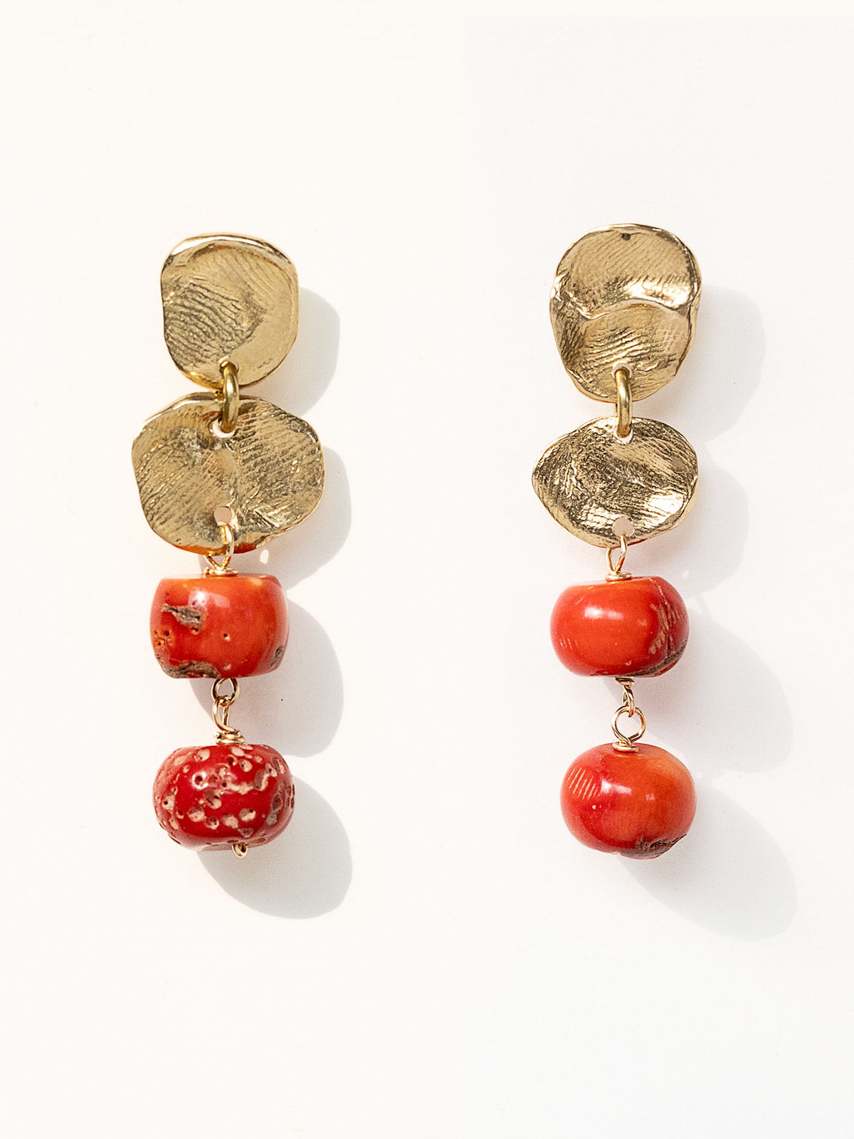 A pair of brass and red drop coral beaded  dangly earrings by Canadian jewelry designer Michelle Ross
