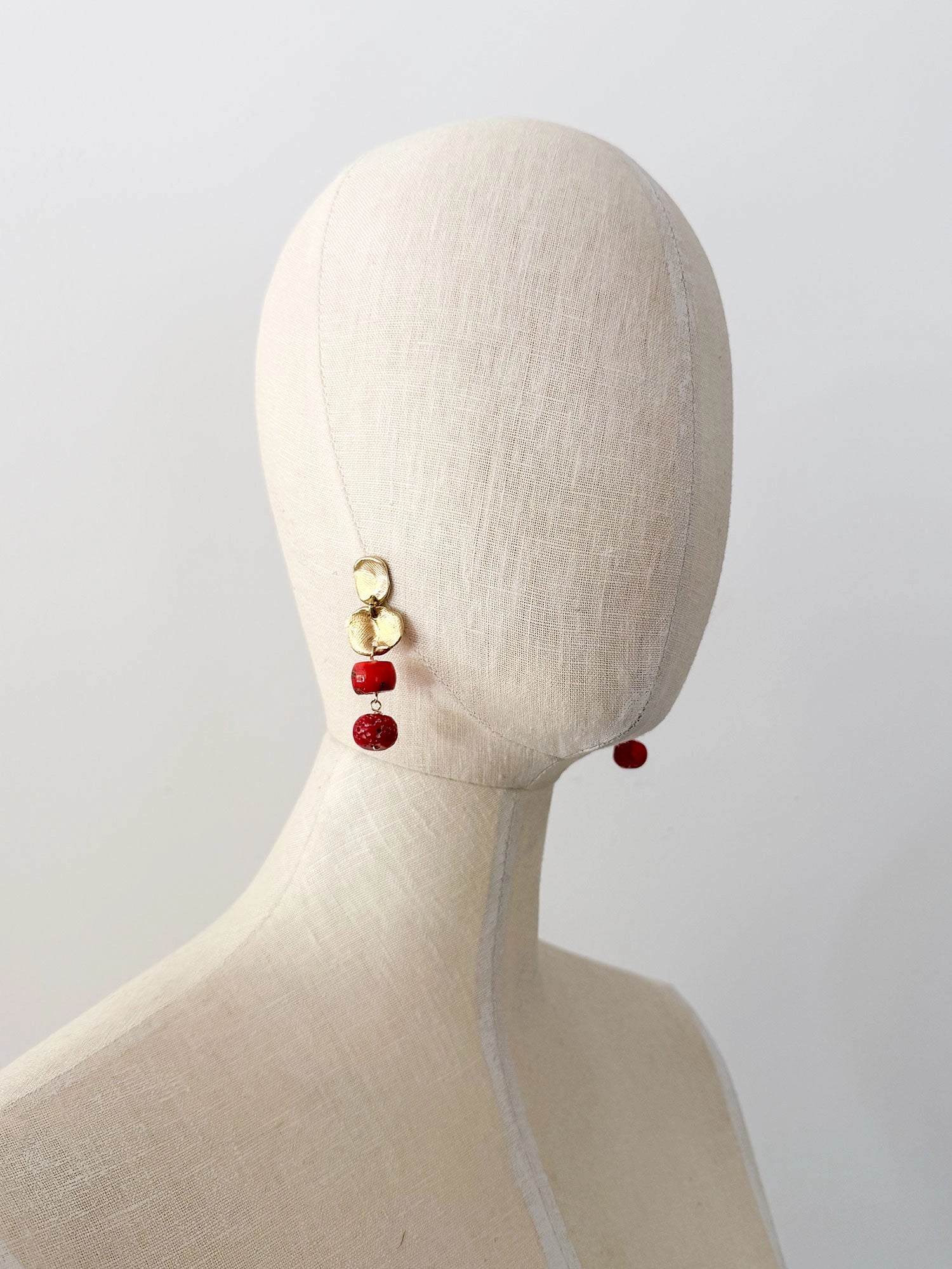 A pair of brass and red drop coral beaded  dangly earrings by Canadian jewelry designer Michelle Ross
