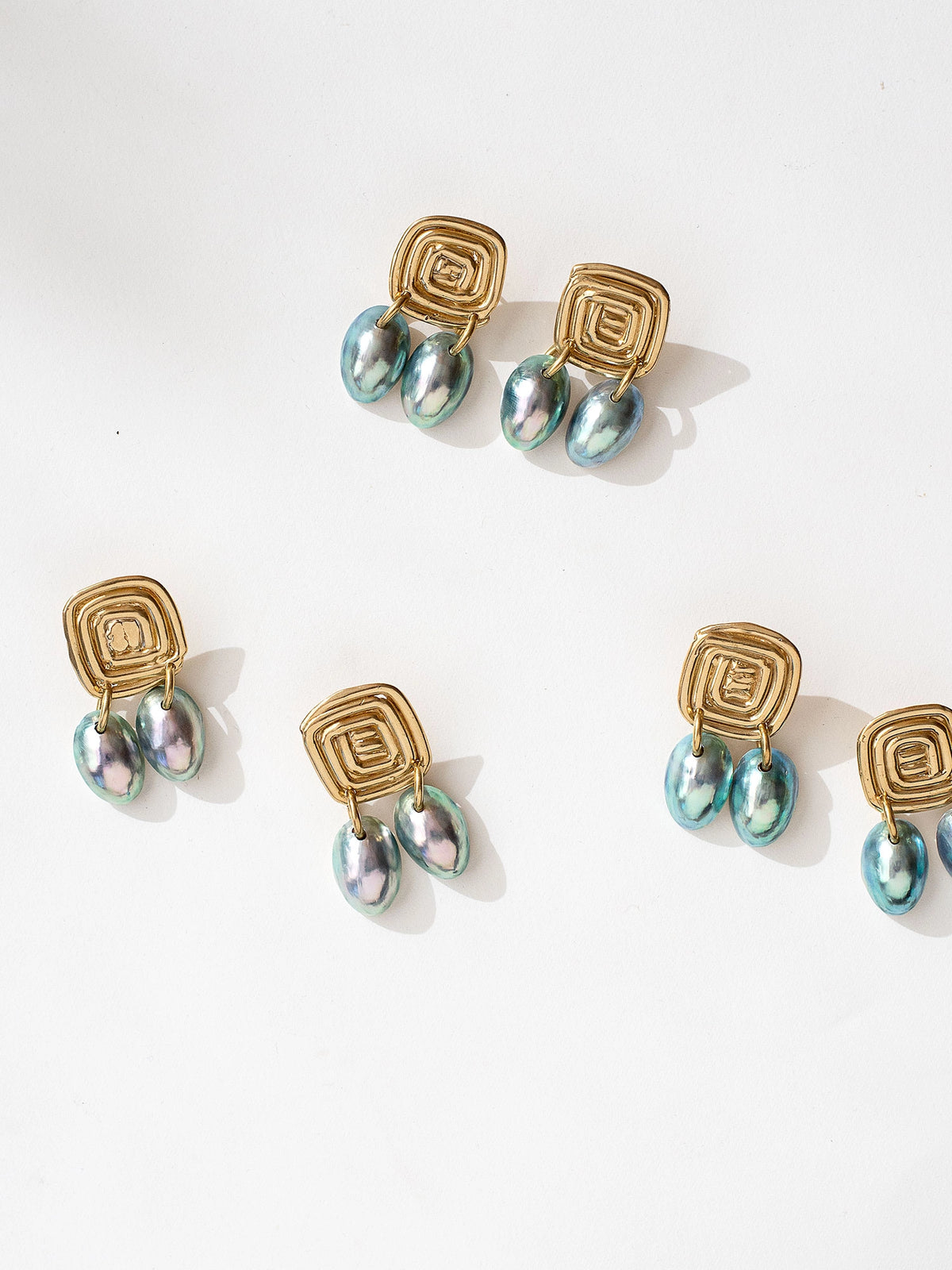 Three pairs of shell and brass statement dangly earrings by Canadian jewelry designer Michelle Ross