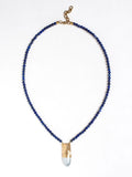 A lapis lazuli beaded necklace with a large statement mother of pearl and brass pendant by Canadian jewellery designer Michelle Ross