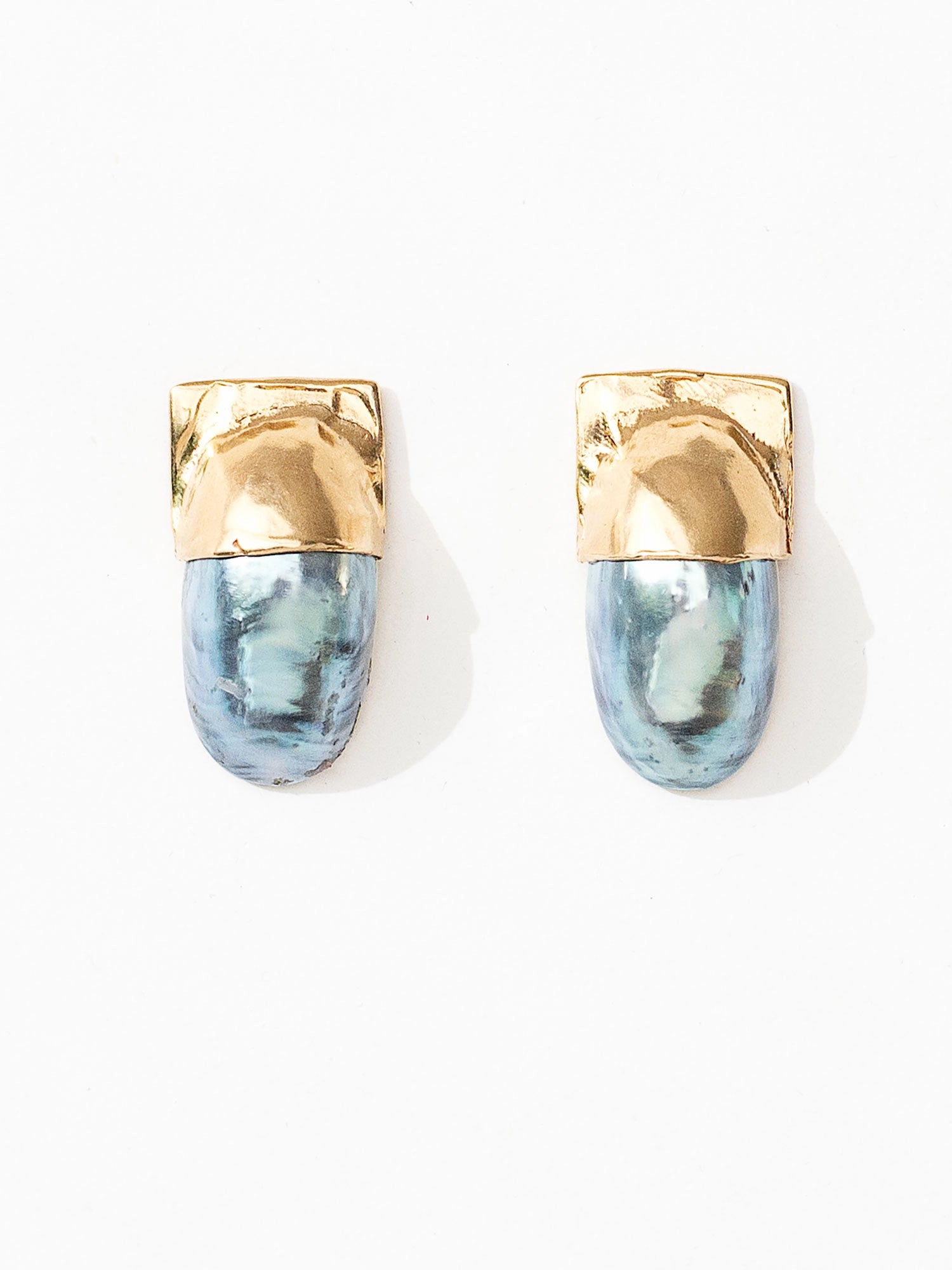 A pair of shell and brass statement stud earrings by Canadian jewelry designer Michelle Ross