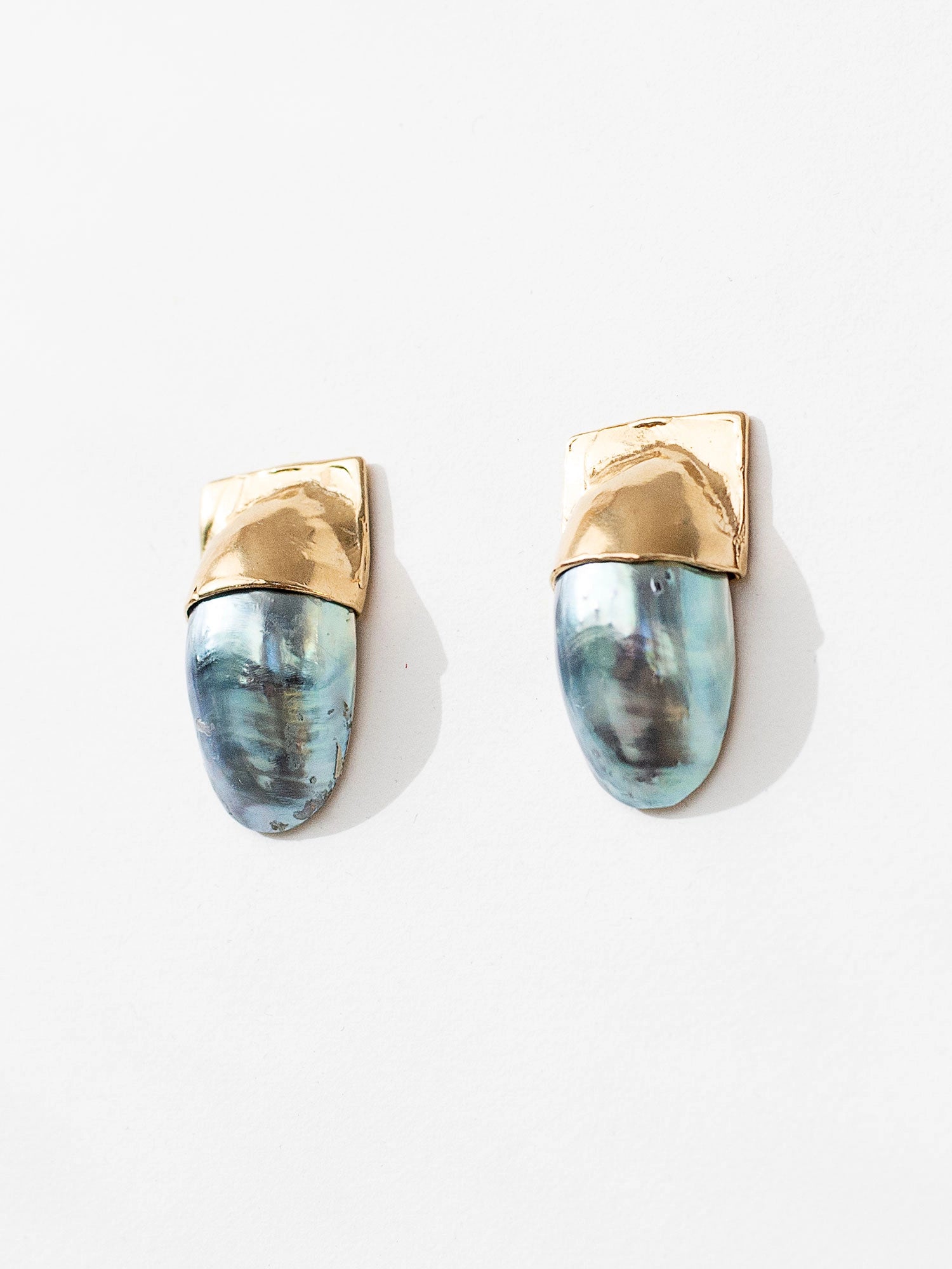 A pair of shell and brass statement stud earrings by Canadian jewelry designer Michelle Ross
