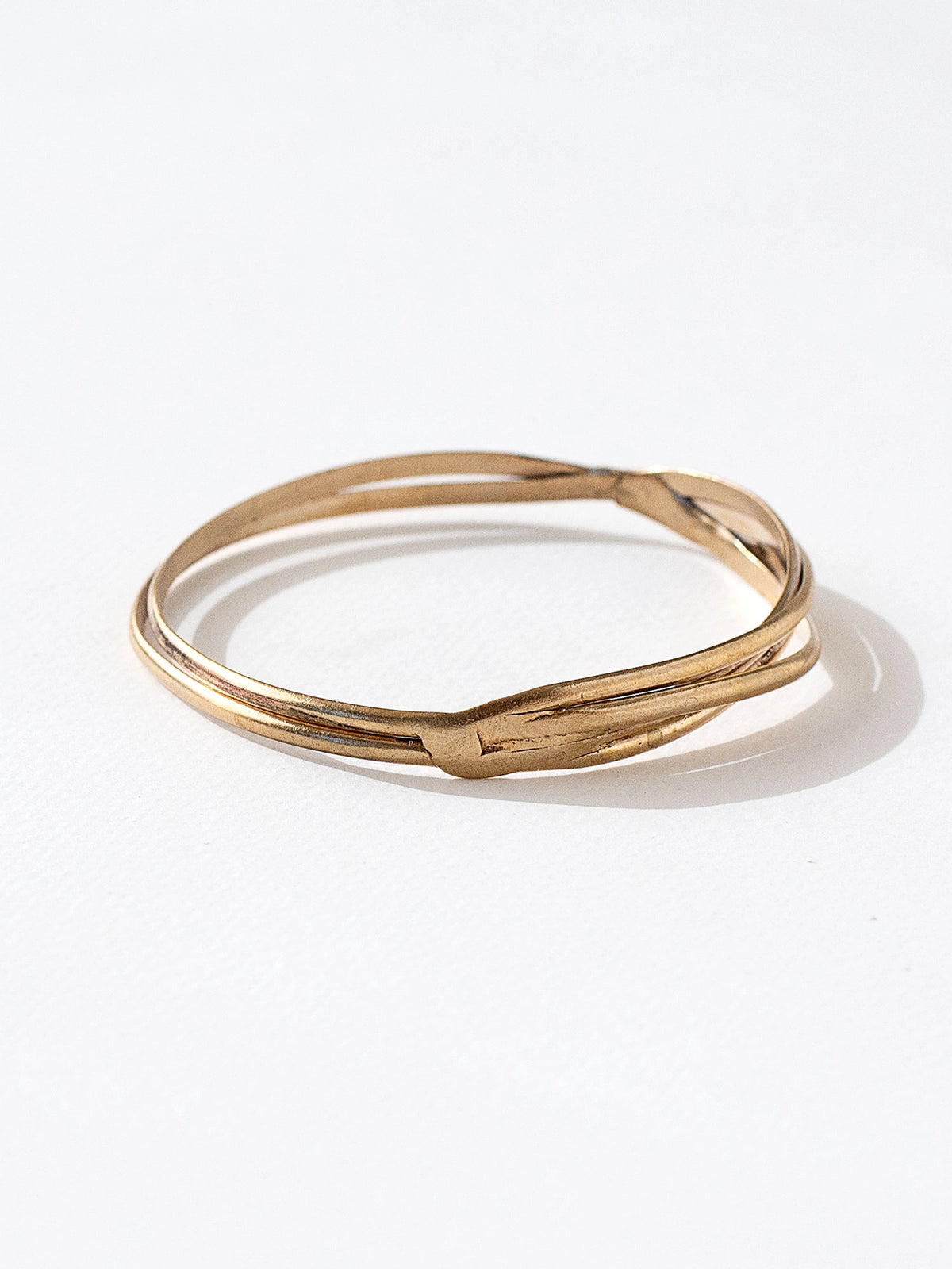 A solid brass stacked bangle bracelet by contemporary jewelry designer Michelle Ross