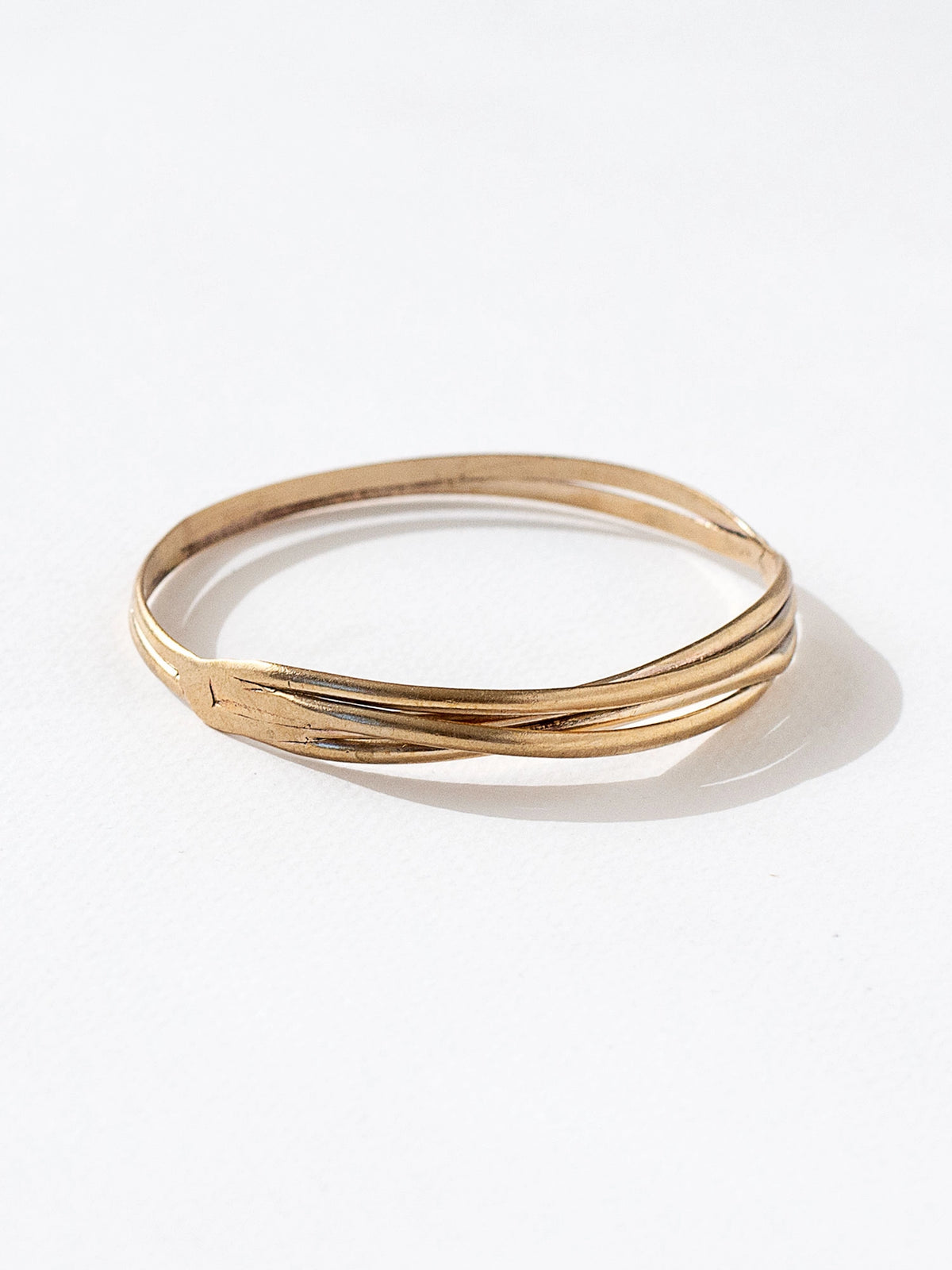 A solid brass stacked bangle bracelet by contemporary jewelry designer Michelle Ross