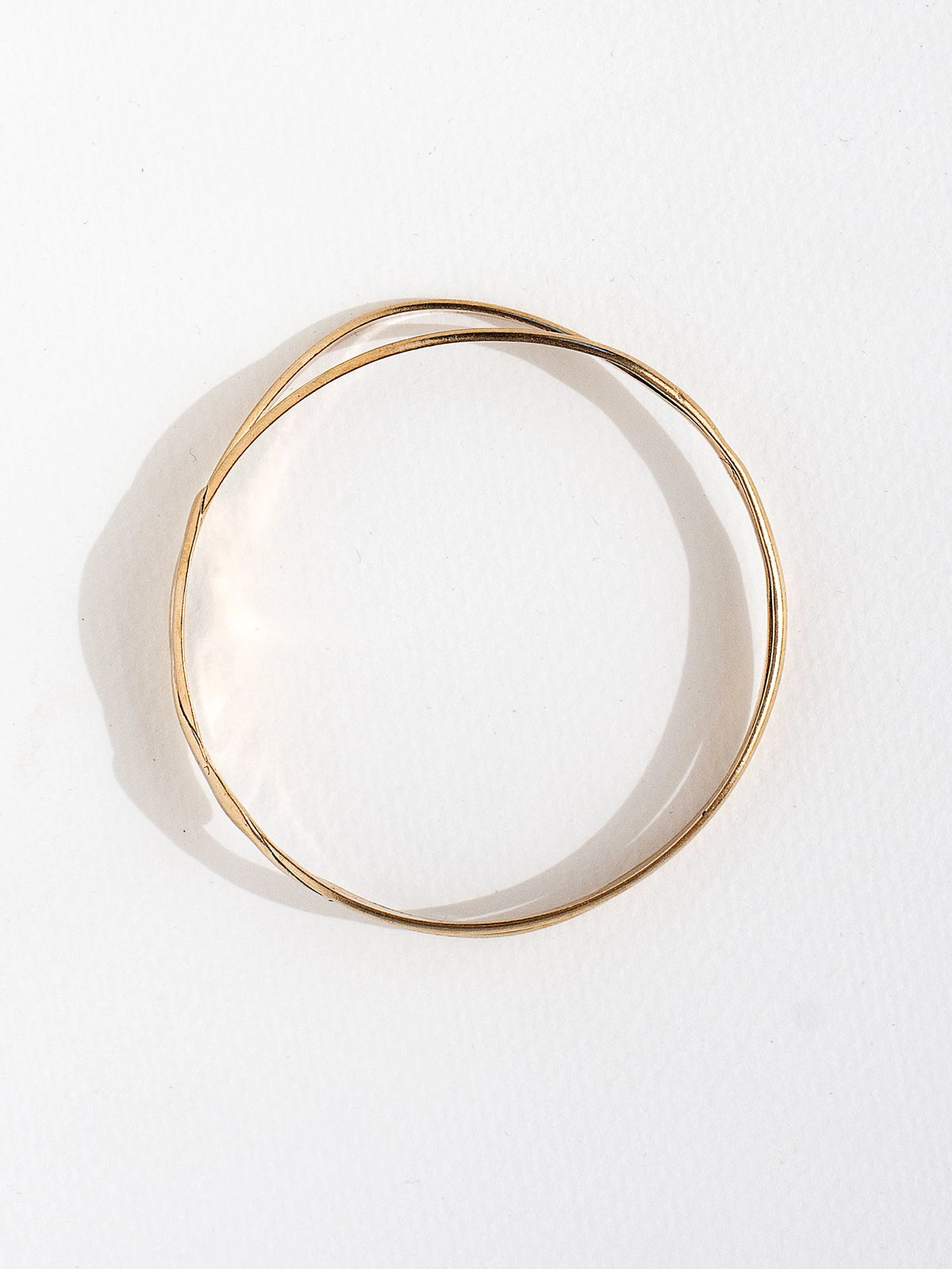 A solid brass stacked bangle bracelet by contemporary jewelry designer Michelle Ross