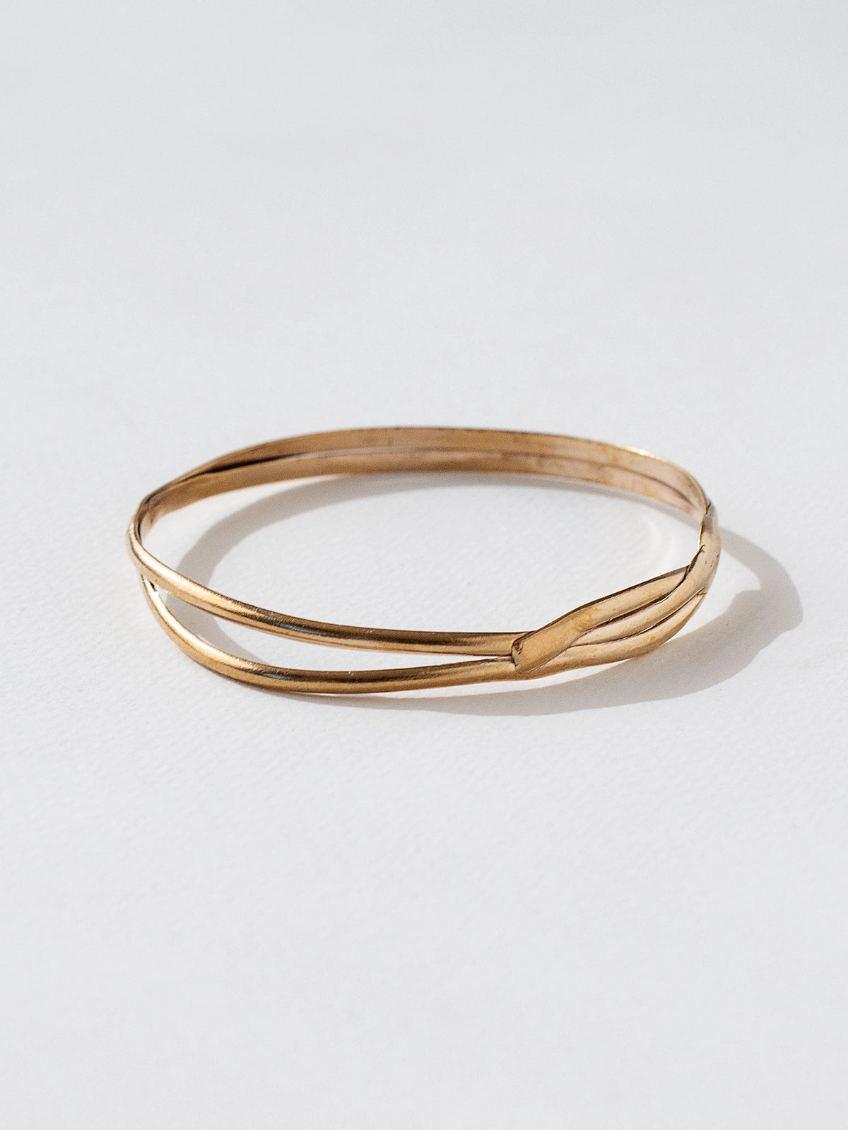 A solid brass stacked bangle bracelet by contemporary jewelry designer Michelle Ross