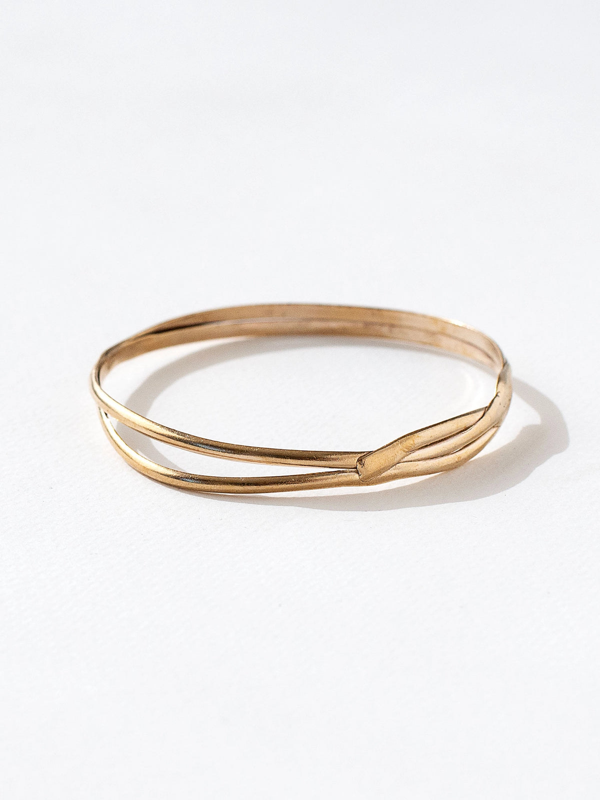 A solid brass stacked bangle bracelet by contemporary jewelry designer Michelle Ross