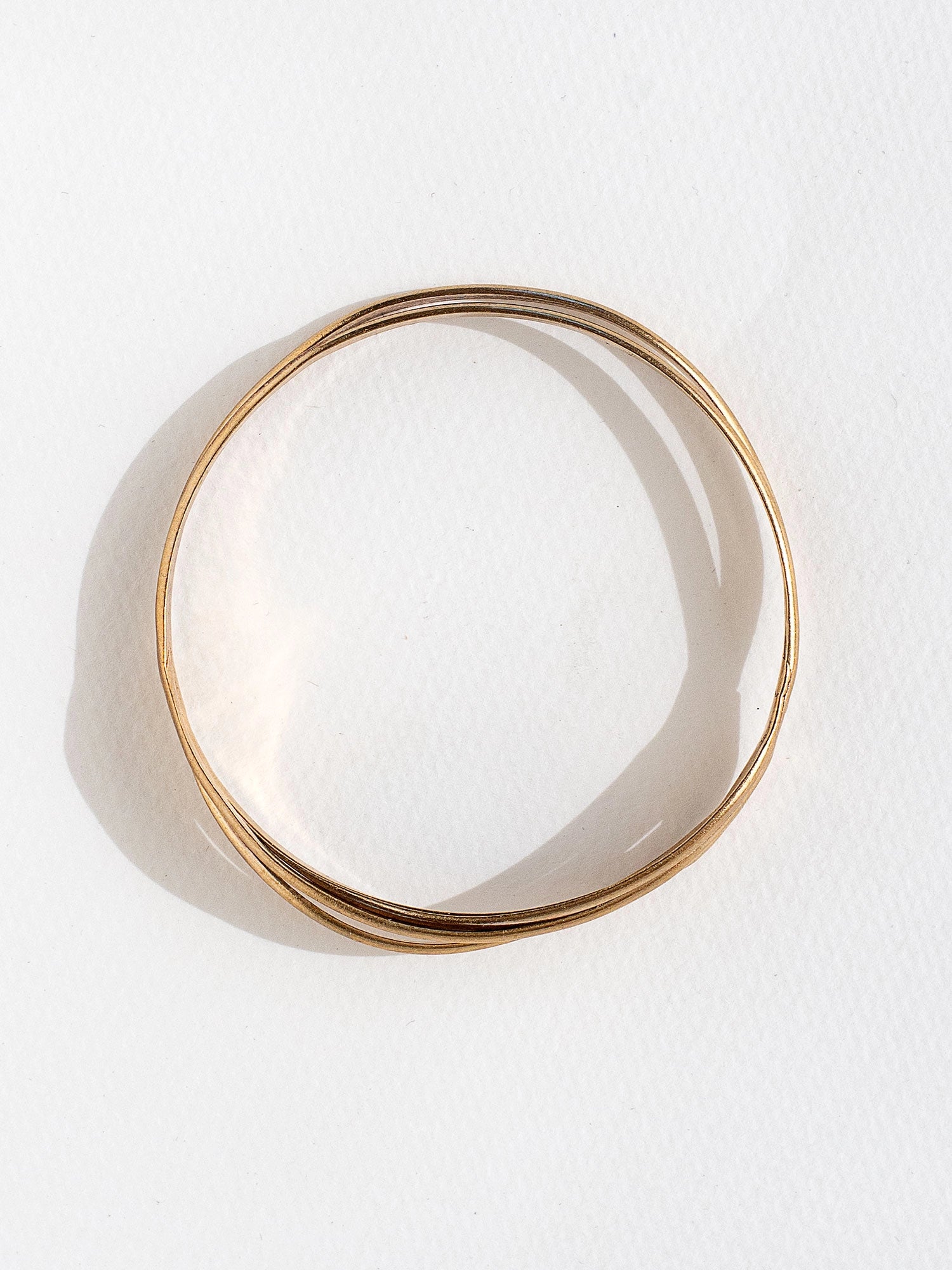 A solid brass stacked bangle bracelet by Canadian jewelry designer Michelle Ross