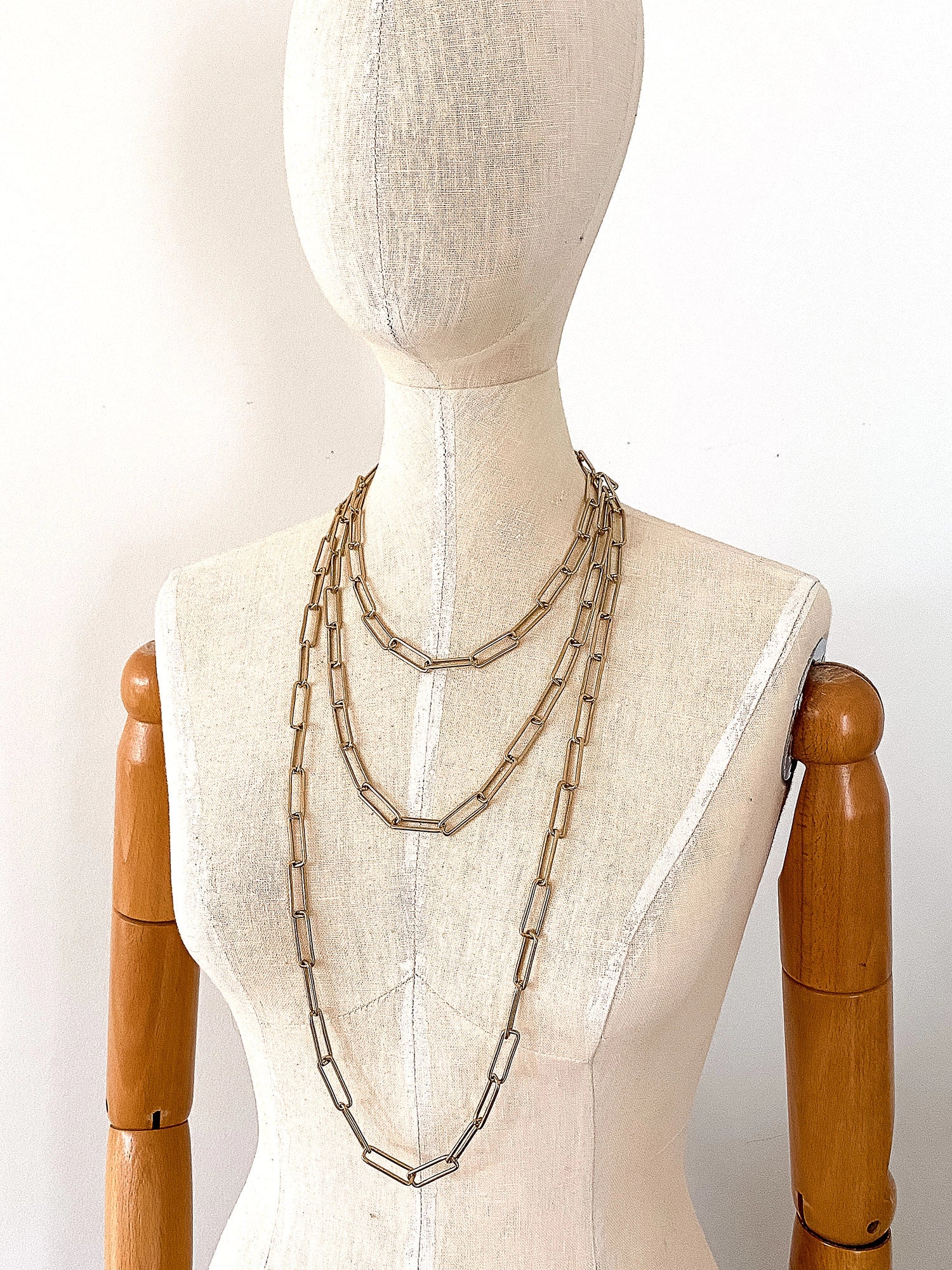 3 Brass Staple Chain Necklaces on a mannequin by Michelle Ross