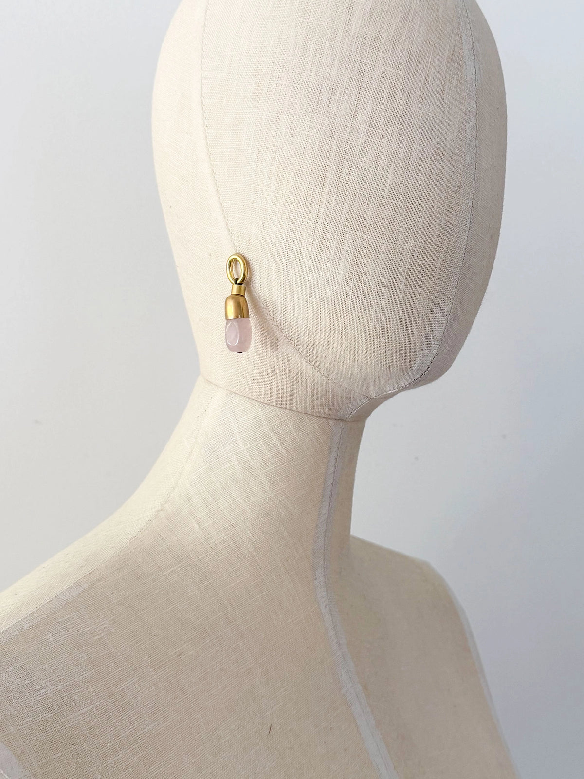 A pair of brass and rose quartz drop earrings by Canadian jewelry designer Michelle Ross
