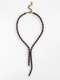 Lariat style necklace with espresso pearl beads and a brass clasp by Michelle Ross