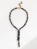 Lariat style necklace with black pink and grey marbled agate beads and a brass clasp by Michelle Ross
