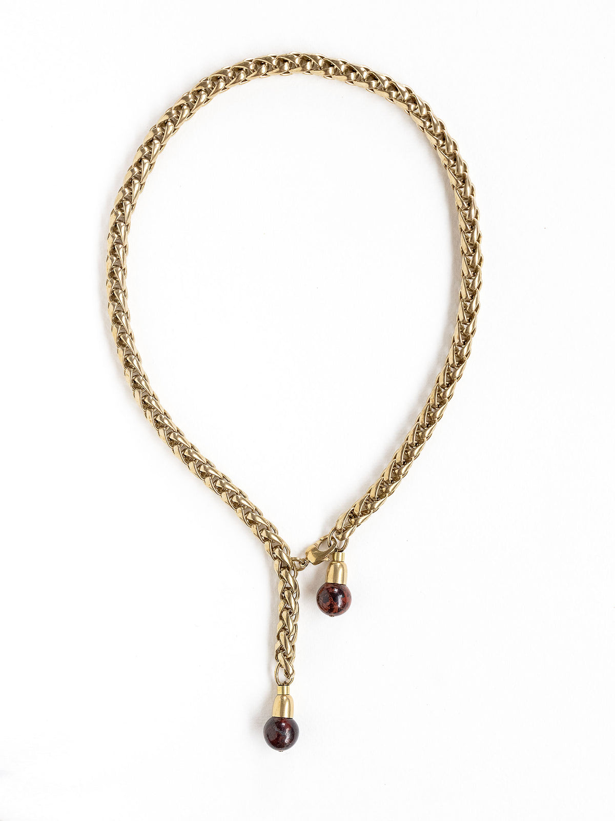 A brass chain lariat necklace with two red jasper bead tassels by Canadian jewelry designer Michelle Ross