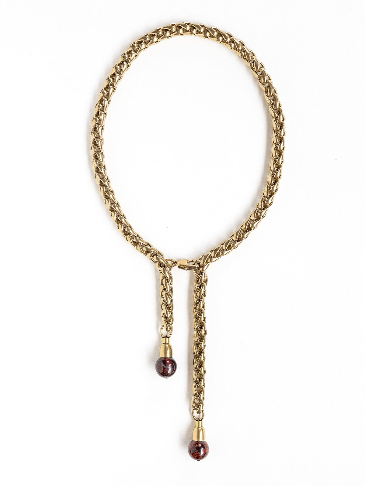 A brass chain lariat necklace with two red jasper bead tassels by Canadian jewelry designer Michelle Ross