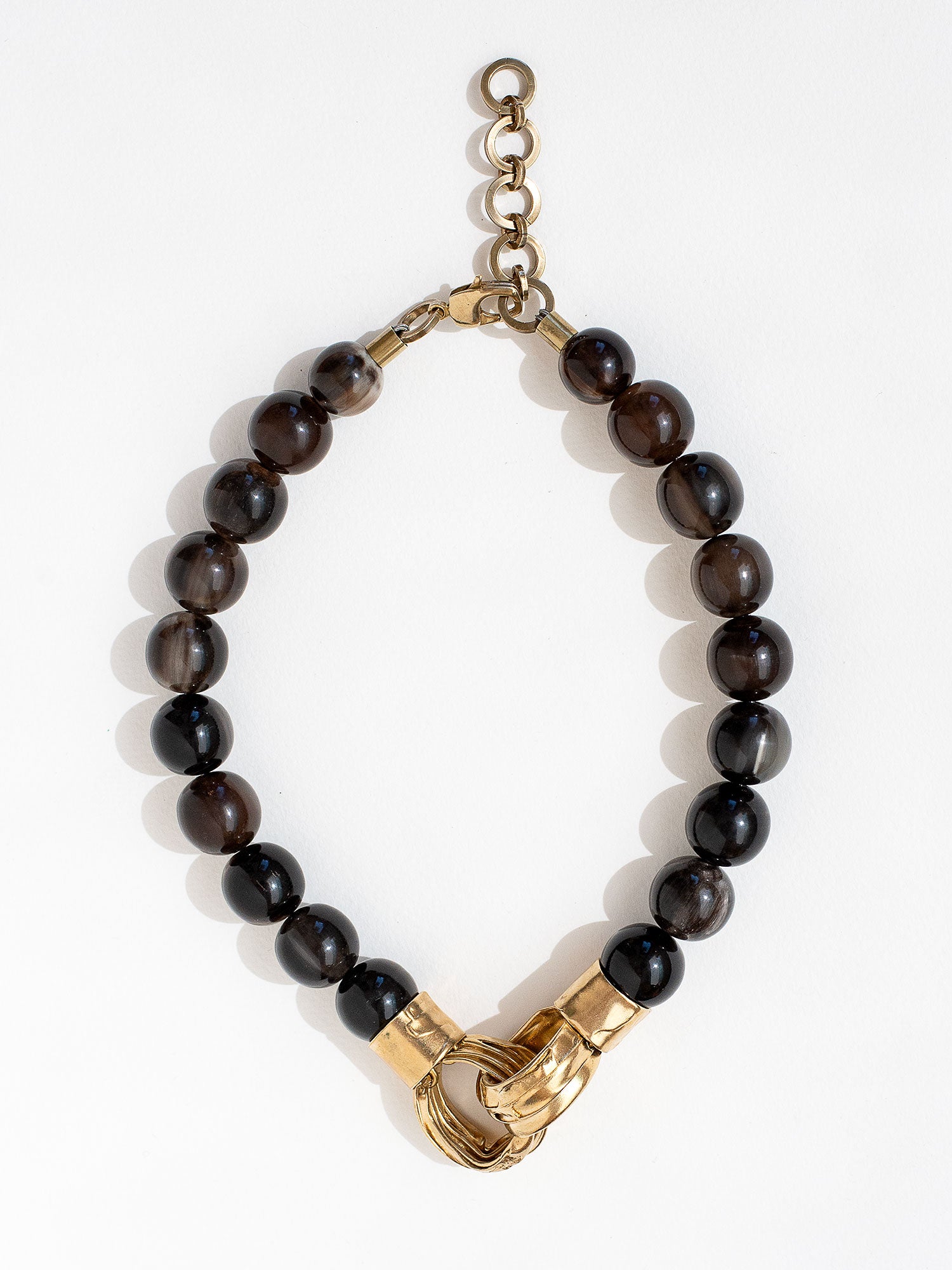 Necklace with horn beads and brass pendant